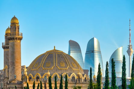 Mosque in foreground; modern skyscrapers behind against a blue sky in Baku