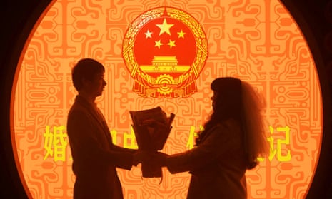 A newly-wed couple pose for pictures on Valentine's Day at a marriage registration office in China.
