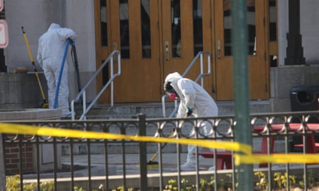 Workers clean the front steps and sidewalk outside Berkey Hall on Tuesday after a shooting at Michigan State University in East Lansing, Michigan.