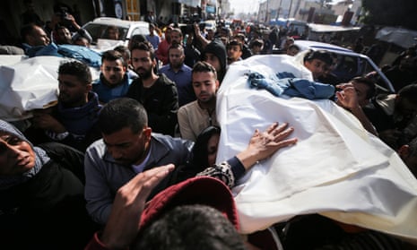 Journalists, relatives and friends carry the bodies of journalists Sary Mansour and Hassouna Sleem.