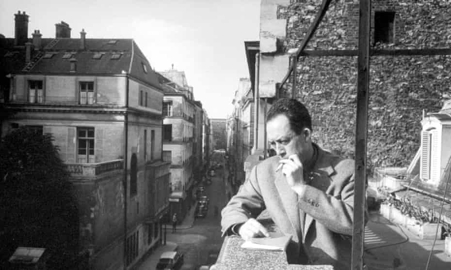 Albert Camus  smoking cigarette on a balcony