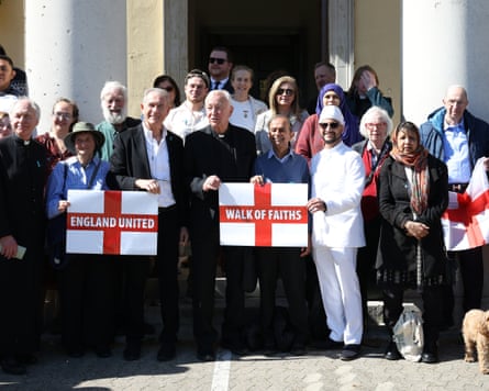 A group of representatives of different faiths holding St George flags