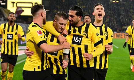 Marco Reus is congratulated by his teammates after scoring from the spot to send Dortmund on their way to victory