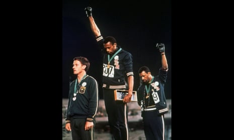 Tommie Smith (centre) and John Carlos raise their gloved fists on the podium at the Mexico Olympics in 1968.