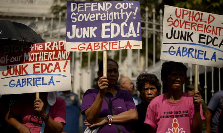 Activists display placards during a protest in Manila against the supreme court ruling that a military accord with the US was constitutional. The US has since been offered use of eight military bases across the nation. 
