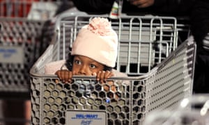 Nevaeh Enoch, 6, peers out from a shopping cart while waiting for a Wal-Mart to open around 5 a.m. Friday, Nov. 28, 2008, in Oakland, California, USA. Hoping for deals on clothes and toys, Enoch and her mom joined the line of several hundred people at 2:45 a.m. (AP Photo/Noah Berger)
