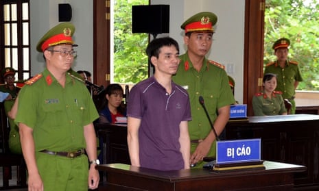 Environmental activist Nguyen Ngoc Anh stands in court during his trial in Vietnam.