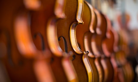 Violins in a row in a shop