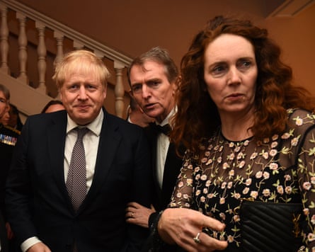 Tony Gallagher (centre), editor-in-chief of the Sun, with Boris Johnson and Rebekah Brooks at the Sun Military Awards, London, 6 February 2020.
