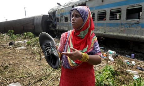 A mother shows a shoe belonging to her missing son, found at the crash site in India