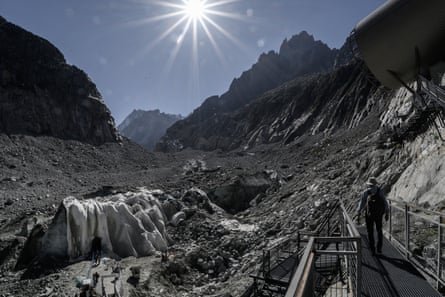 A tourist in the French Alps under a blazing sun.