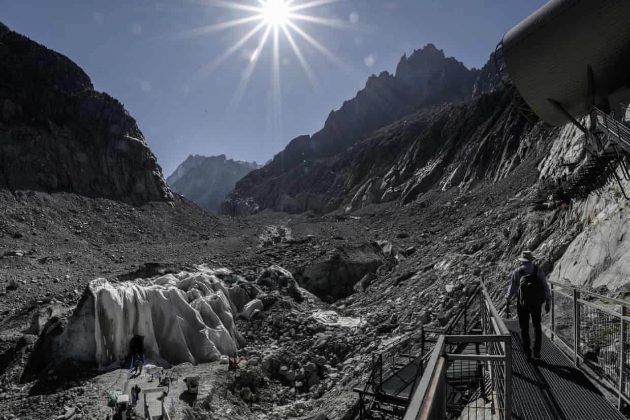 A tourist in the French Alps under a blazing sun.