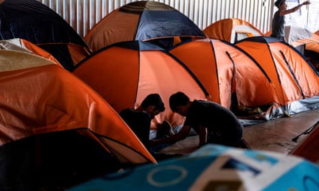 Asylum seekers play at a migrant shelter in Tijuana, Baja California state, Mexico, on 18 October. 