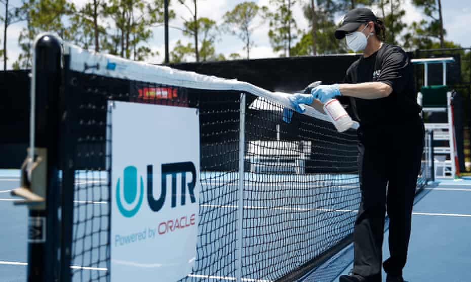 A worker cleans a tennis net in West Palm Beach, Florida. Some US cleaning companies have been busier than ever.