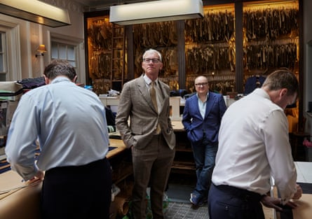 Tom Holland and Dominic Sandbrook wearing suits in a tailors’ workshop