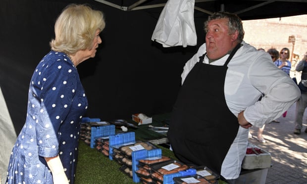 The Duchess of Cornwall speaks to a butcher in Salisbury