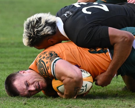Australia's Isaac Henry is tackled by New ZealandâÂÂs Filipo Daugunu