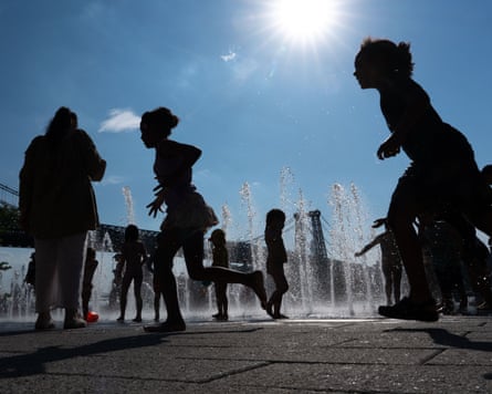 People play in the fountains in Brooklyn.
