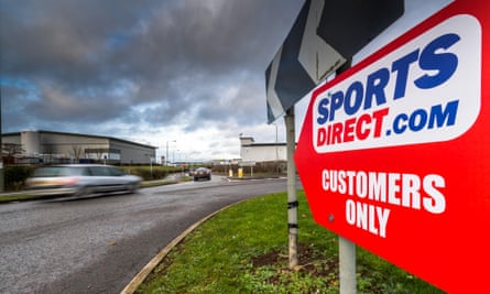 Red sign next to road that says Sports Direct.com customers only