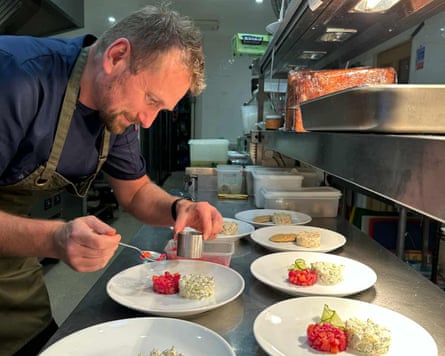 A chef prepares food in the kitchens of the Glenuig Inn in the Highlands
