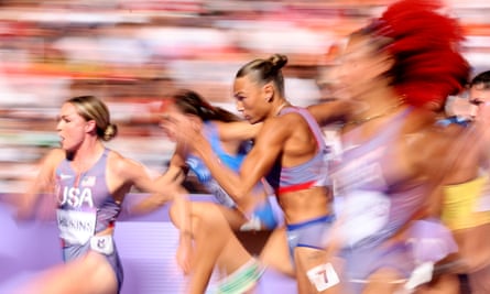 A blurred photo of women sprinting, including Anna Hall (c) of Team United States
