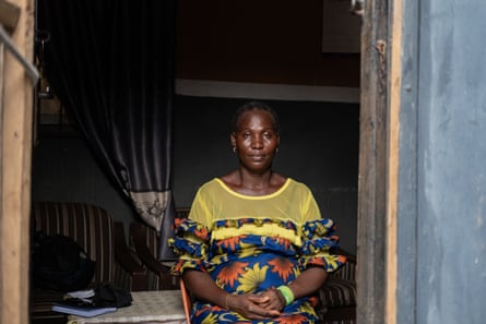 Bosede Onifade stands just inside the doorway of a house with her hands clasped.