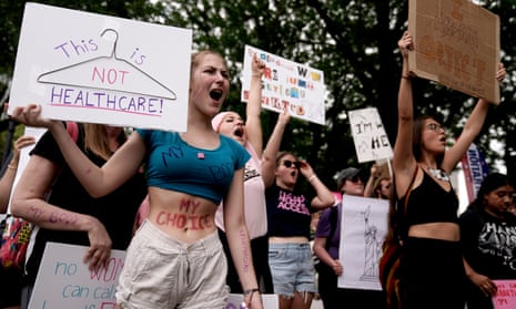 Abortion rights protesters gather with signs.