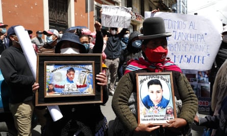 Women hold photos of victims killed during clashes that happened between security forces and supporters of former president Evo Morales when Bolivia’s former interim president Jeanine Áñez was in power, outside the police station where she is being held in La Paz, Bolivia, at the weekend.