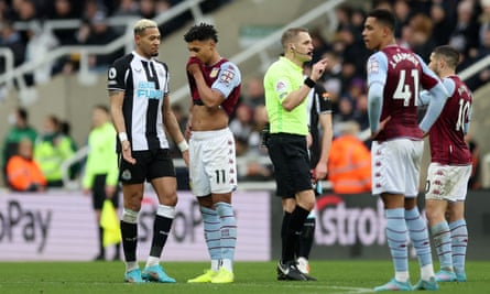 Aston Villa’s Ollie Watkins speaks with Newcastle United’s Joelinton before VAR disallows a goal for Aston Villa