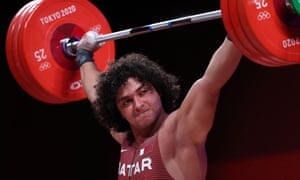 Fares Ibrahim El=Bakh of Qatar competes during the men’s 96kg weightlifting at the Tokyo Olympic Games.