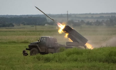 Ukrainian servicemen fire a rocket from a BM21 Grad multiple launch system in the Kharkiv region