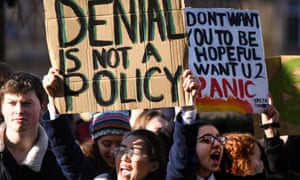 Schoolchildren hold signs protesting climate change