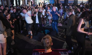 People dance to the music of a busker in Leicester Square