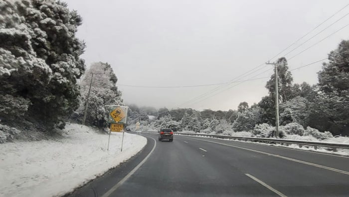 Australia news live: budget to prioritise childcare and health costs; at least 25 Covid deaths recorded 4 Snow lines the road at Grove in the Huon Valley, south of Hobart.