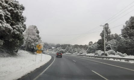 Snow lines the road at Grove in the Huon Valley, south of Hobart.
