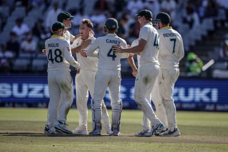 Australia’s Marnus Labuschagne is mobbed by teammates after a run out