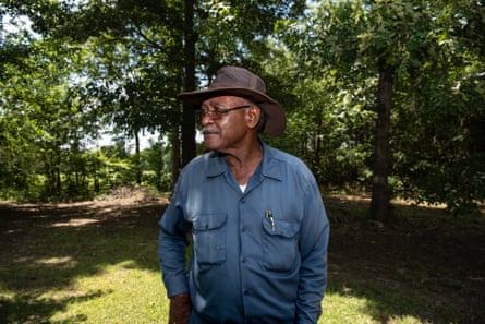 a man in a blue collard shirt with a hat