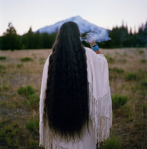 Chief Caleen Audrey Sisk Franco - the spiritual leader and last speaker of her tribe’s language- sends smoke prayers toward Mount Shasta in California.