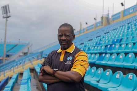 Martin Mokgwathi standing near rows of blue seats in a stadium