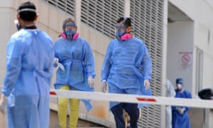 Relatives of deceased patients wearing protective outfits arrive for their remains at Los Ceibos hospital in Guayaquil, Ecuador on 8 April 2020, amid the coronavirus outbreak.
