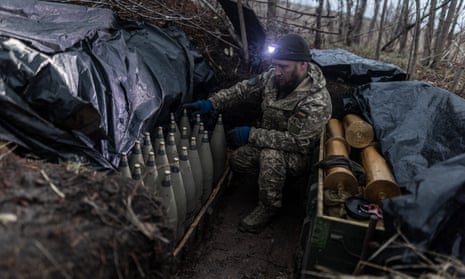 A Ukrainian soldier checks shells at his fighting position in the direction of Bakhmut, Ukraine.