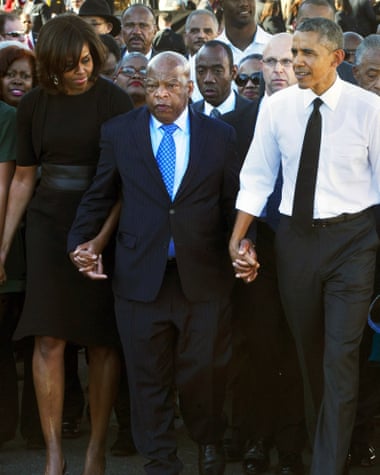 President Barack Obama and his wife Michelle hold hands with Rep. John Lewis, while marching to mark the 50th anniversary of the Bloody Sunday events in 1965.