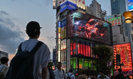 Pedestrians watch an advert for Final Fantasy XVI, one of Japan’s biggest video games, in Shinjuku, Tokyo. (Photo by Richard A. Brooks / AFP) / To go with “Japan-games-Final Fantasy”, POINTS by Katie Forster (Photo by RICHARD A. BROOKS/AFP via Getty Images)