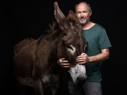 Bruno Lötscher, vet, who lost his house in Brienz, pictured with his donkey Lola