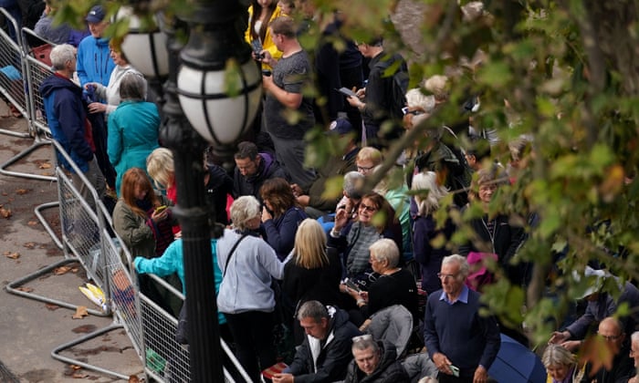 Crowds gather along The Mall ahead of the ceremonial procession of the coffin of Queen Elizabeth II from Buckingham Palace to Westminster Hall, London.