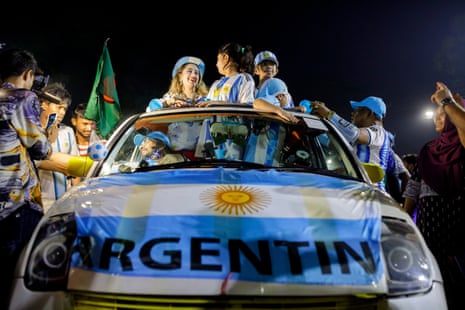 A Bangladeshi family of soccer fans in their car.