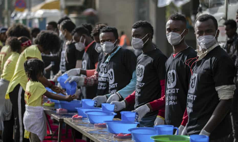 Volunteers in Ethiopia at soap and water stations at a fun run in the capital Addis Ababa. Global coronavirus deaths and infections have outstripped those inside China for the first time. 