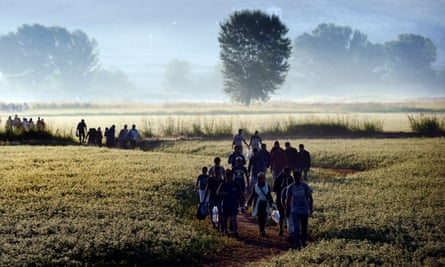 Syrian refugees cross the border between Greece and Macedonia in 2015.