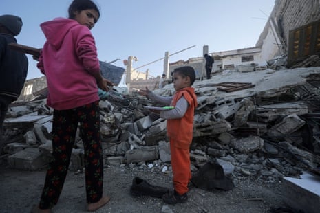 Children near the rubble of a destroyed house after an Israeli airstrike in the east of Deir al-Balah.