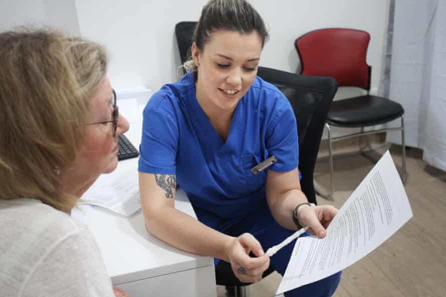 A patient speaks with a nurse ahead of receiving the Covid AstraZeneca vaccine at a medical practice in Sydney on 23 March.